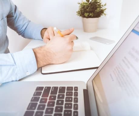 writing notes on search engine optimisation SEO next to computer